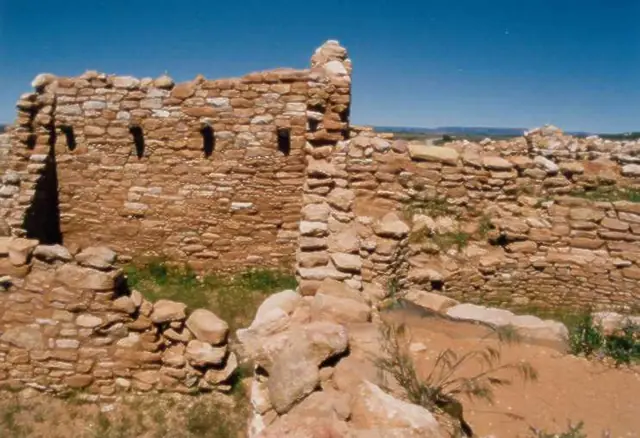 Sandstone walls of the Ancestral Puebloan village ruin at Edge of the Cedars under a blue sky