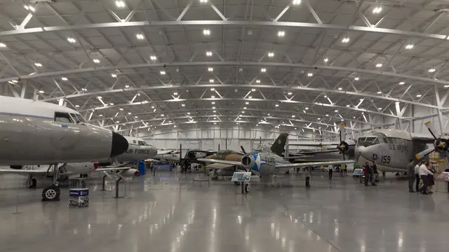 Rows of military aircraft on a polished floor inside the L.S. Skaggs Gallery hangar at Hill Aerospace Museum
