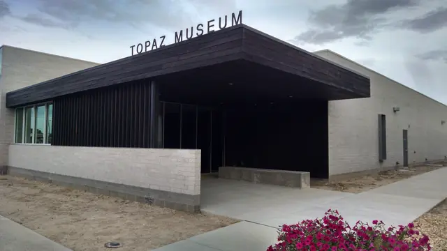 The Topaz Museum in Delta, a low building with a dark wood entry canopy and the museum name on the roofline